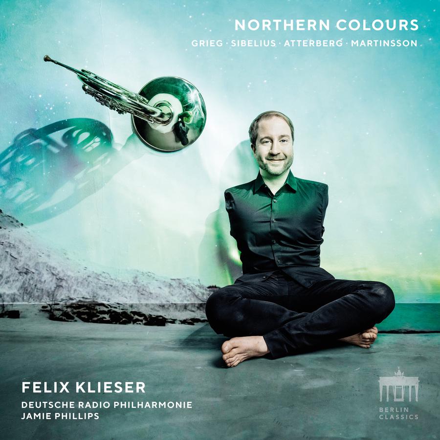 Release-Cover „Northern Colours“ von Hornist Felix Klieser mit Deutsche Radio Philharmonie unter Jamie Phillips. Porträt von Felix Klieser sitzend vor arktischer Landschaft, daneben ein schwebendes Horn; kühle Türkis- und Blautöne, surreale Frontalansicht und klare Lichtstimmung.