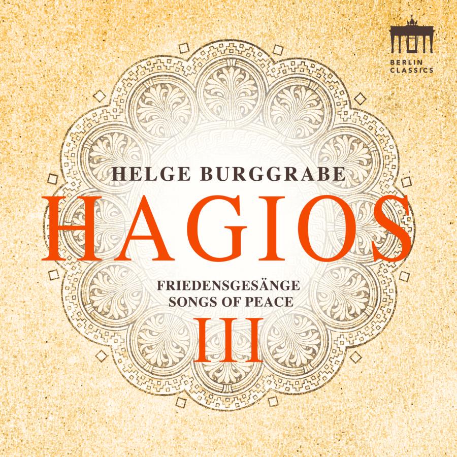 Grafisches Cover vom Album Hagios III (Songs of Peace) von Helge Burggrabe. Der Hintergrund ist sandfarben und zentriert darüber ein Mandala ähnliches, symmetrisches Muster auf dem der Titel in oranger Schrift steht.